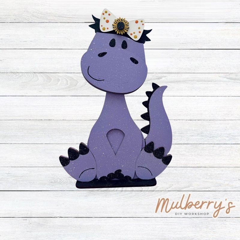 Our brachiosaurus dinosaur is super cute! It's approximately 13" tall and can be paired with your favorite seasonal/holiday insert.

This set includes the interchangeable brachiosaurus dinosaur and the sunflower headbow insert. Please note that we currently offer only one sunflower insert option.

Please note that different inserts fit each type of dinosaur base differently.
