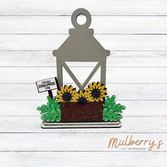 We love our interchangeable lantern! It's approximately 11" tall and can display your favorite seasonal/holiday insert.

This set includes the interchangeable lantern and the sunflower insert.