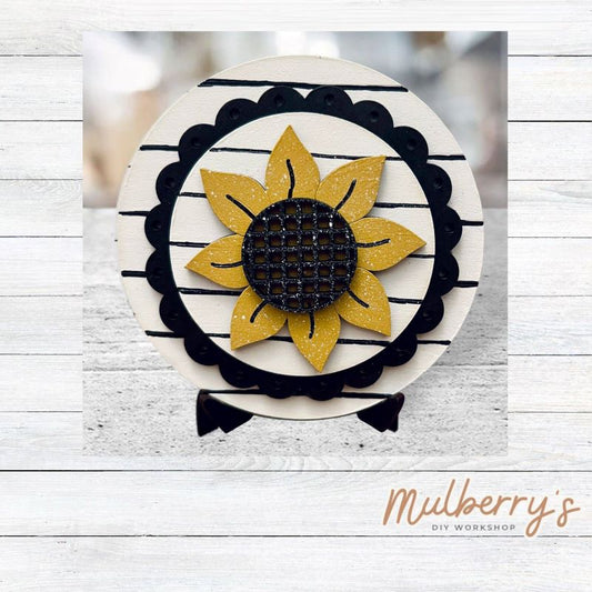 We love our mini interchangeable round stand! It's approximately 4.5 inches in diameter and can display your favorite seasonal/holiday insert.

This set includes mini interchangeable round stand with scallop and sunflower insert.