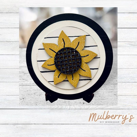 We love our mini interchangeable round stand! It's approximately 4.5 inches in diameter and can display your favorite seasonal/holiday insert.

This set includes mini interchangeable round stand with circle and sunflower insert.