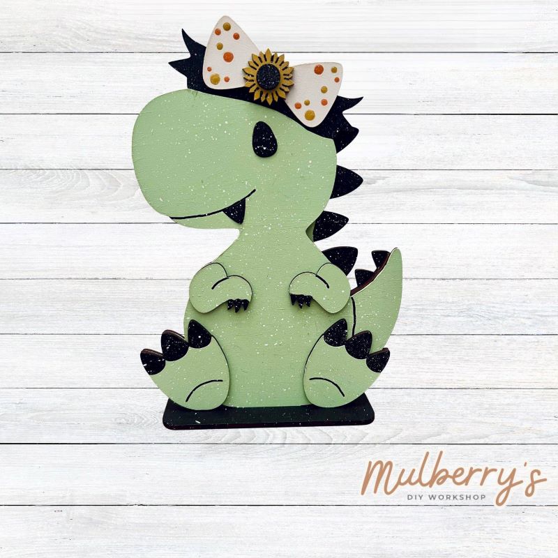 Our t-rex dinosaur is super cute! It's approximately 8" tall and can be paired with your favorite seasonal/holiday insert.

This set includes the interchangeable t-rex dinosaur and the sunflower headbow insert. Please note that we currently offer only one sunflower insert option.

Please note that different inserts fit each type of dinosaur base differently.