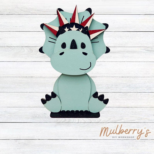Our triceratops dinosaur is super cute! It's approximately 11.5" tall and can be paired with your favorite seasonal/holiday insert.

This set includes the interchangeable triceratops dinosaur and your choice of July 4th inserts:

-Headband with Bow Tie

-Headbow

-Statue of Liberty Spike Hat

Please note that different inserts fit each type of dinosaur base differently. For our interchangeable triceratops, we recommended pairing it with the statue of liberty spike hat insert.