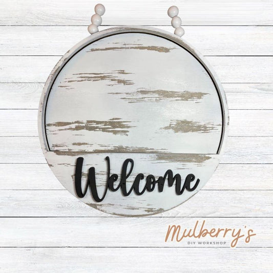 Our Welcome Door Hanger is 10.5-inches in diameter. We offer a variety of interchangeable inserts to decorate for each season and holiday.